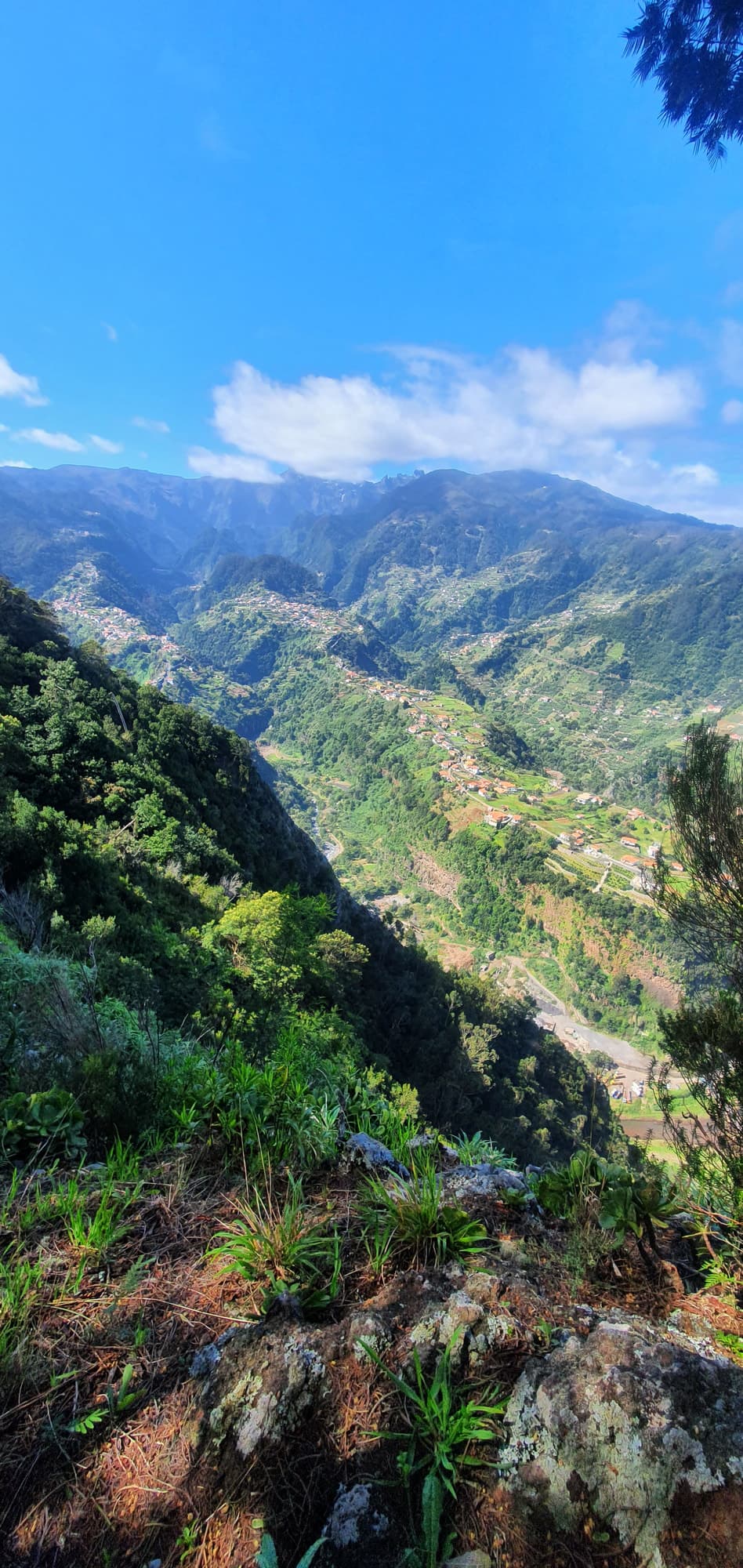 Terraced villages in a green mountain valley
