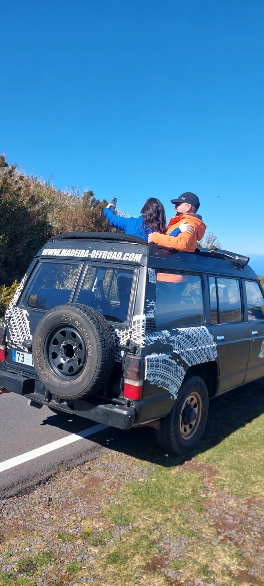 Guests enjoying the view from the open-roof Nissan Patrol