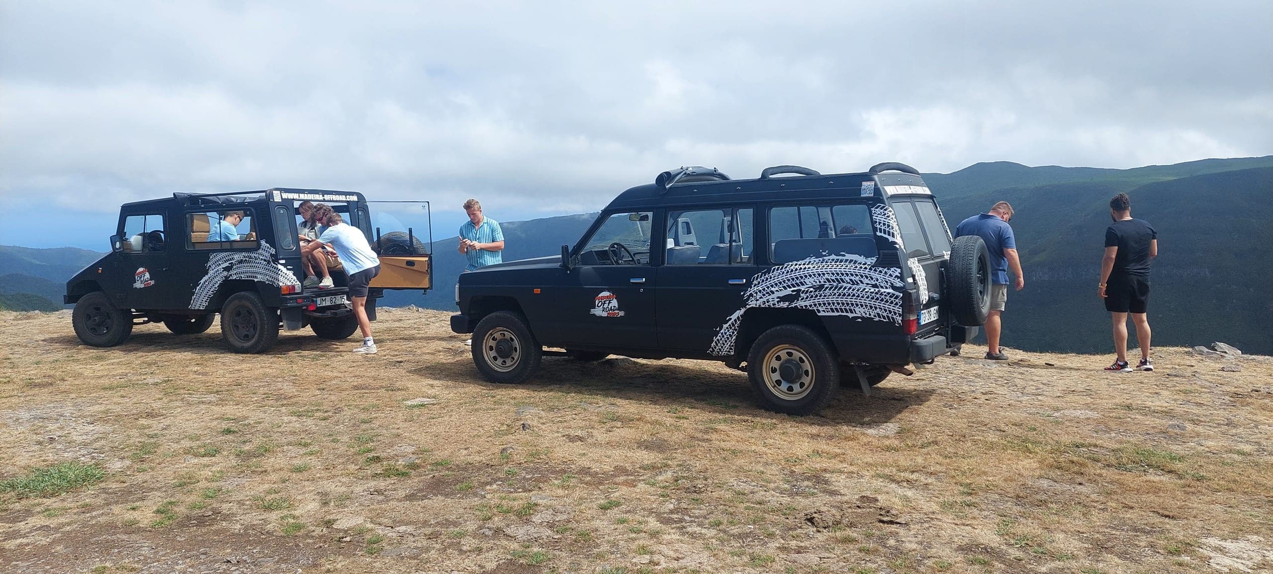 Two Madeira Off Road Jeeps parked on a high plateau with guests taking in the view